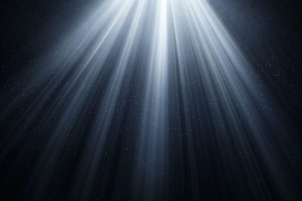 Rays of ethereal light descend from an unseen source above, illuminating the darkness below. This creates a sense of wonder, awe, and the possibility of something greater beyond the visible.